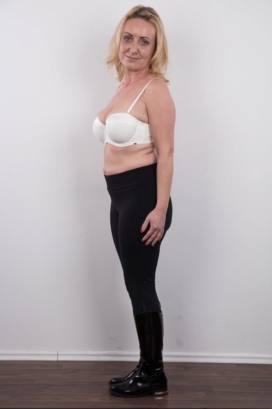 Middle-aged blonde lady Gerlinda stands totally nude after disrobing