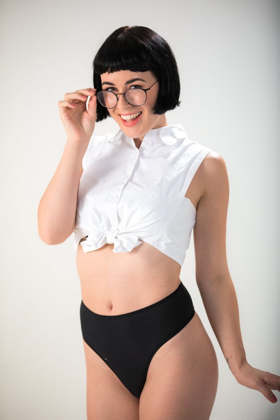 Dark haired chick Olive Glass removes glasses before standing naked