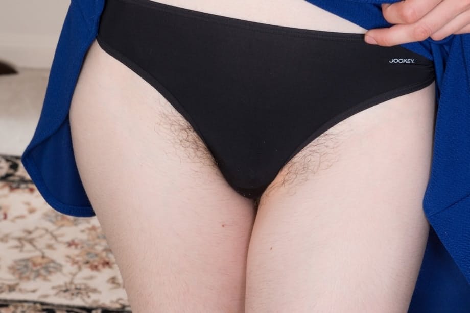 Hairy brunette Silki Smith undresses before parting her beaver