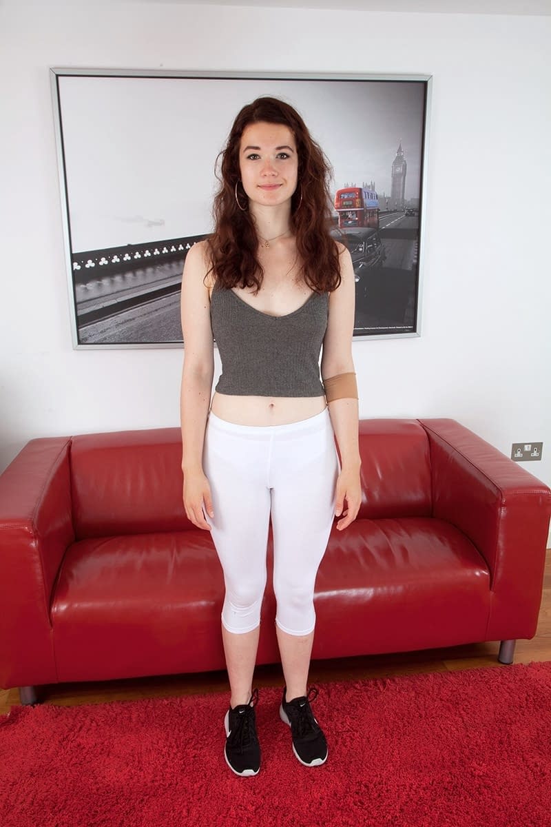 Pretty teen Flora slips her yoga pant down to flash her hairy muff