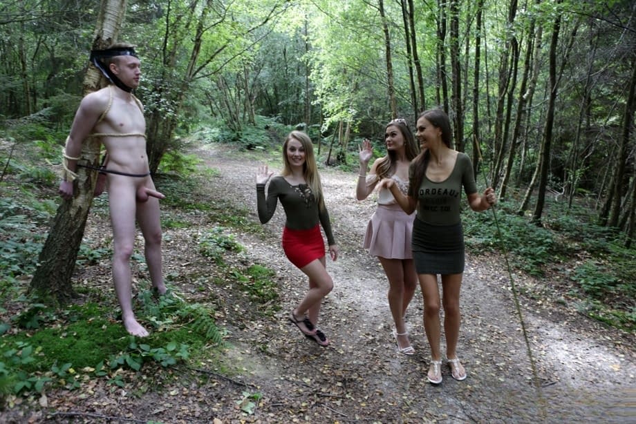 3 young girls walking in the woods find a restrained man and suck his cock