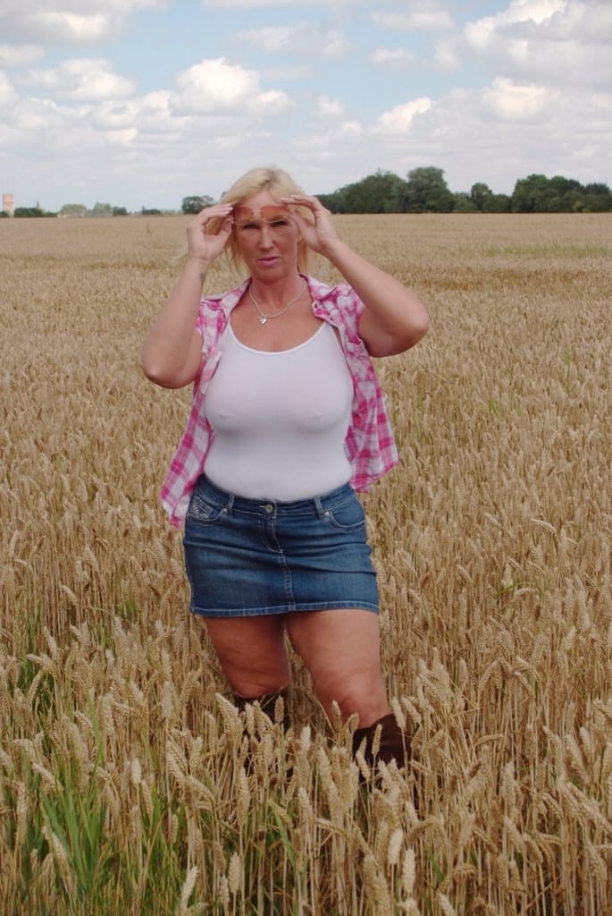 Chubby mature MILF Melody reveals great big tits & flashes hot ass in a field