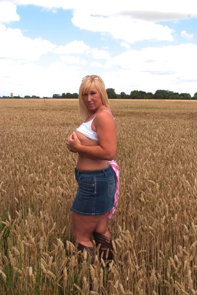 Chubby mature MILF Melody reveals great big tits & flashes hot ass in a field