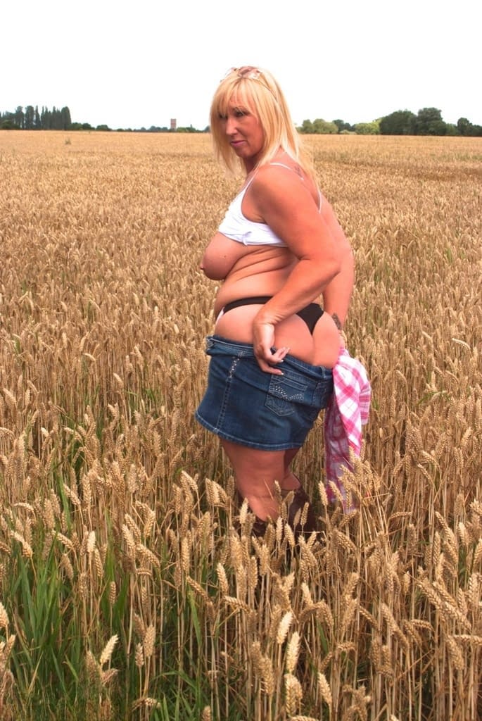 Chubby mature MILF Melody reveals great big tits & flashes hot ass in a field