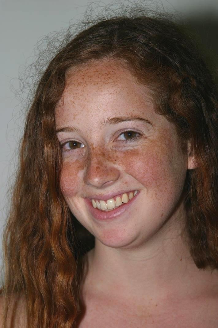 Redhead with freckles and big tits parts her natural pussy after getting naked