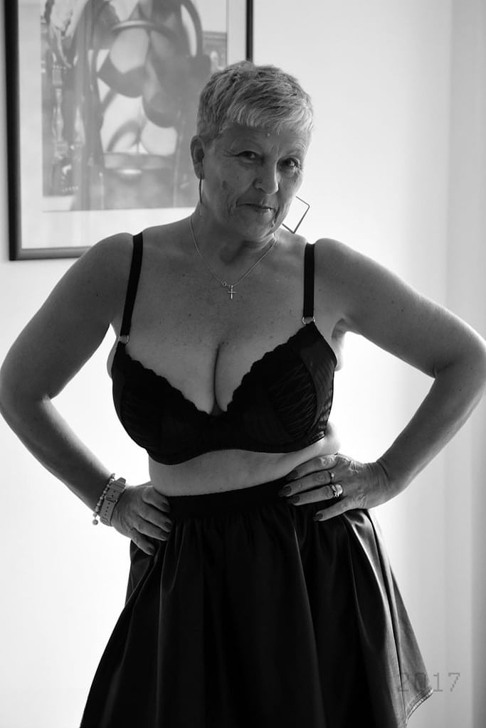 Old woman with short hair and floppy tits dons a strapon in fishnet pantyhose