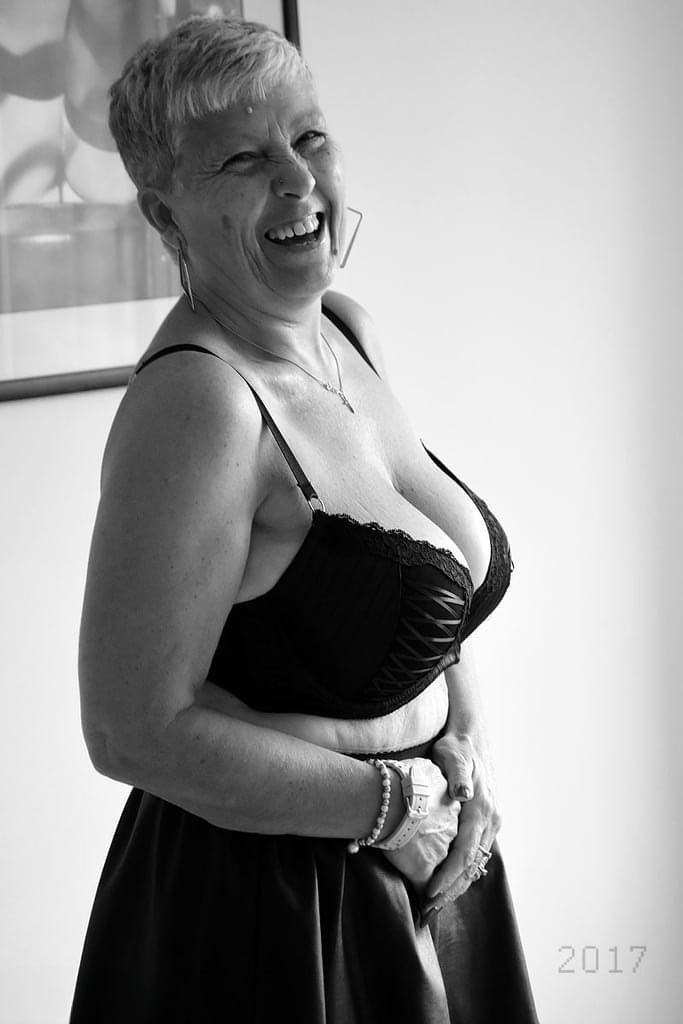 Old woman with short hair and floppy tits dons a strapon in fishnet pantyhose