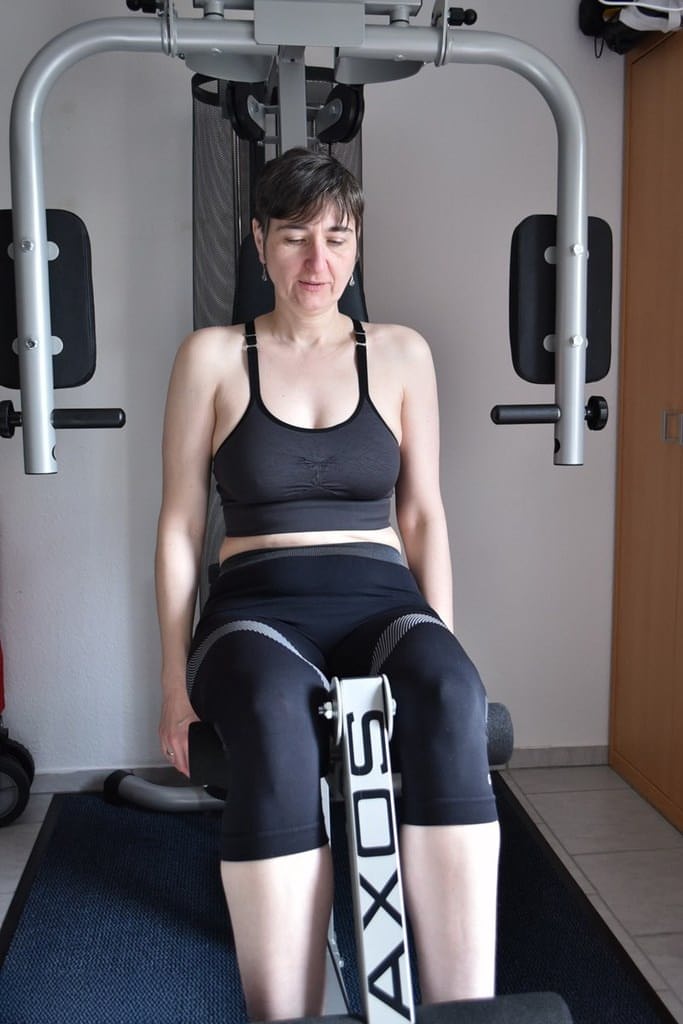 Fit older lady shows off her saggy tits while working out at the gym