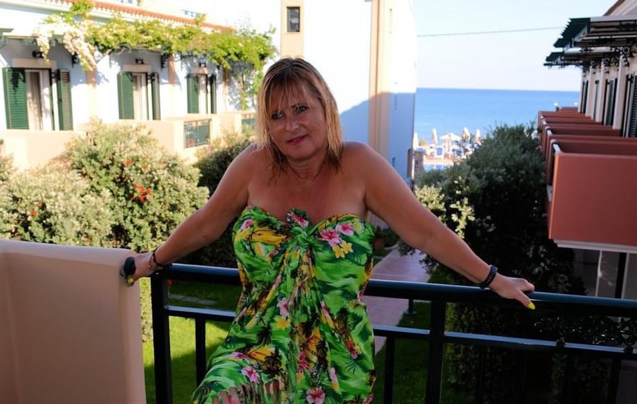 Slutty mature nudist with large tits Chrissy shows her hot curves at the beach