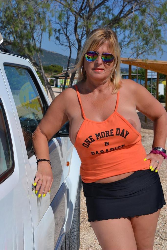 Slutty mature nudist with large tits Chrissy shows her hot curves at the beach