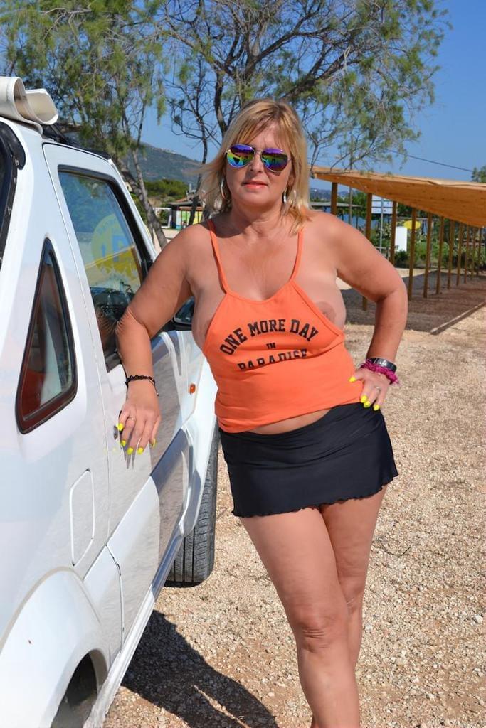 Slutty mature nudist with large tits Chrissy shows her hot curves at the beach