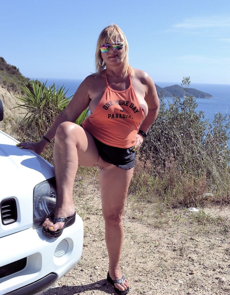 Slutty mature nudist with large tits Chrissy shows her hot curves at the beach