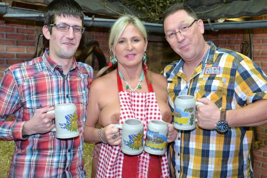 Thick blonde serves beer with big boobs out after putting in wood in the nude