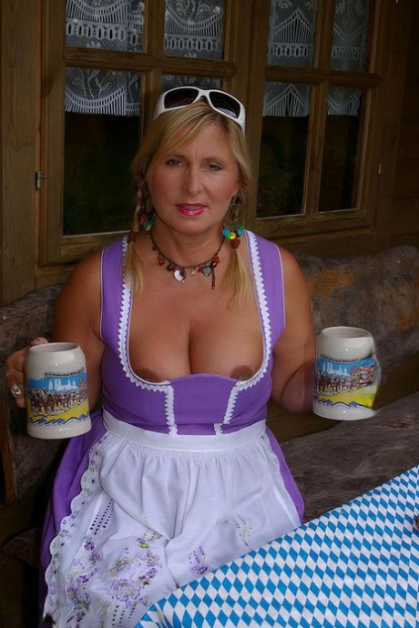 Thick blonde serves beer with big boobs out after putting in wood in the nude