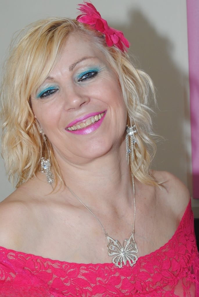 Mature sexy Platinum Blonde pulls down red lace dress to expose big saggy tits