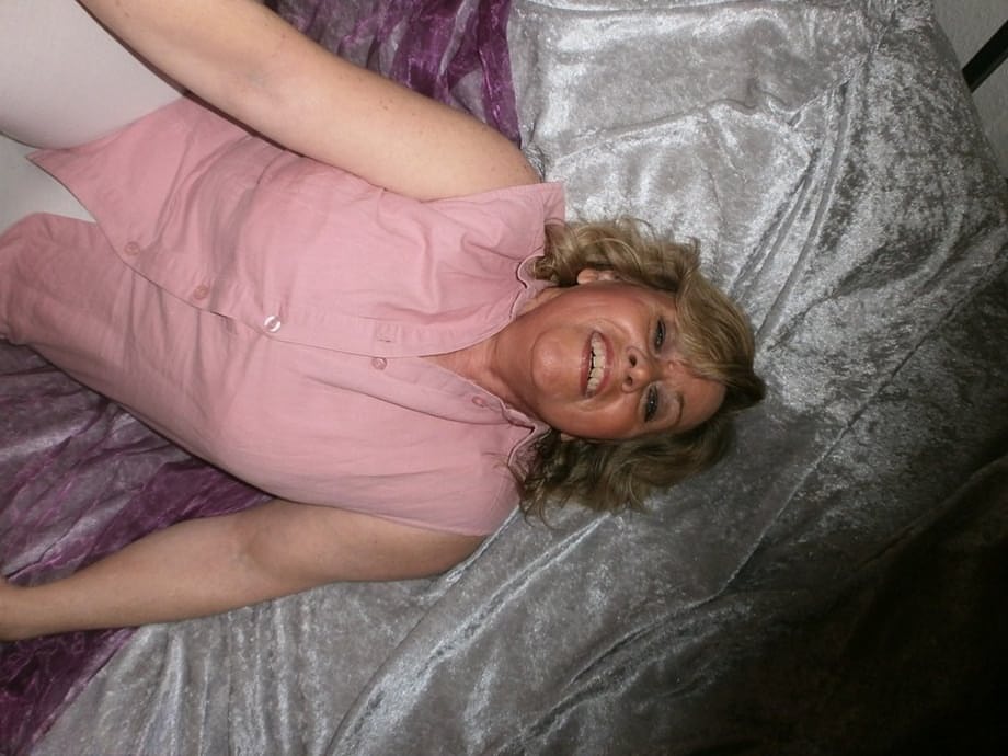 Mature woman Caro slides her white leggings over her granny panties