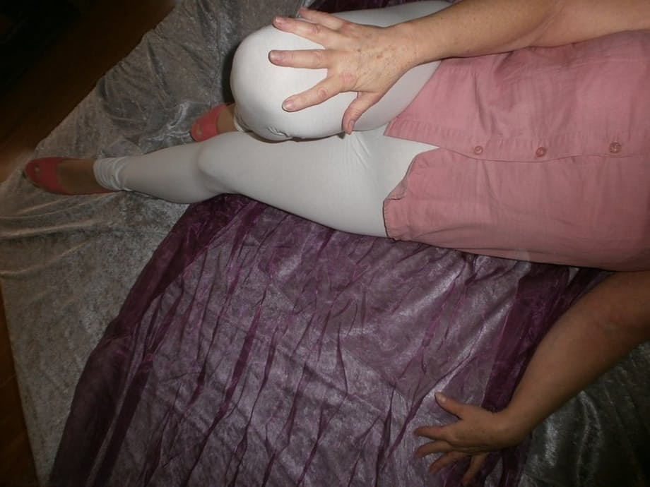 Mature woman Caro slides her white leggings over her granny panties