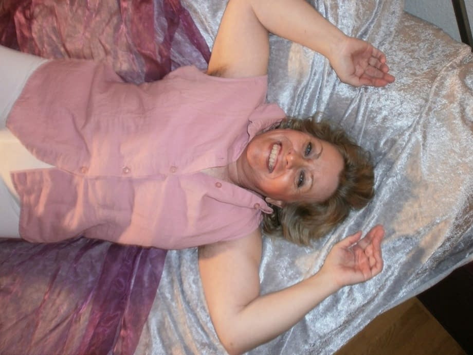Mature woman Caro slides her white leggings over her granny panties
