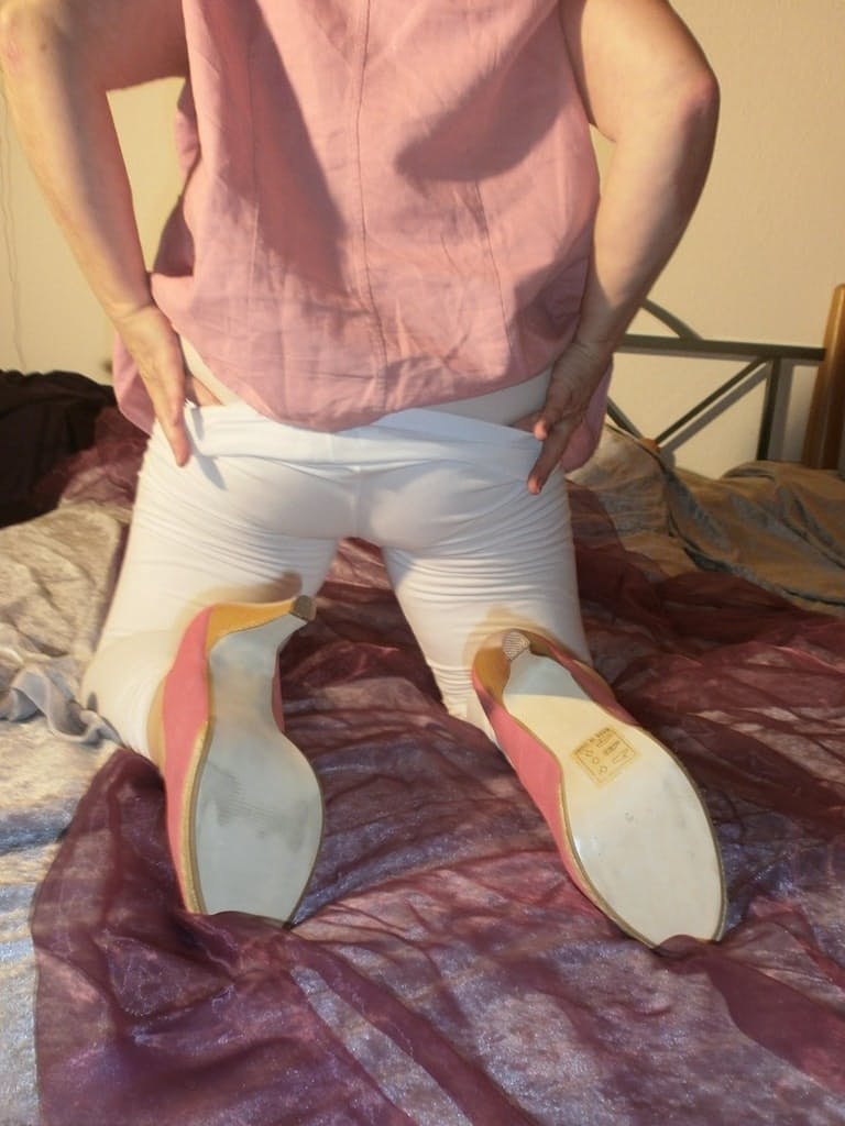 Mature woman Caro slides her white leggings over her granny panties