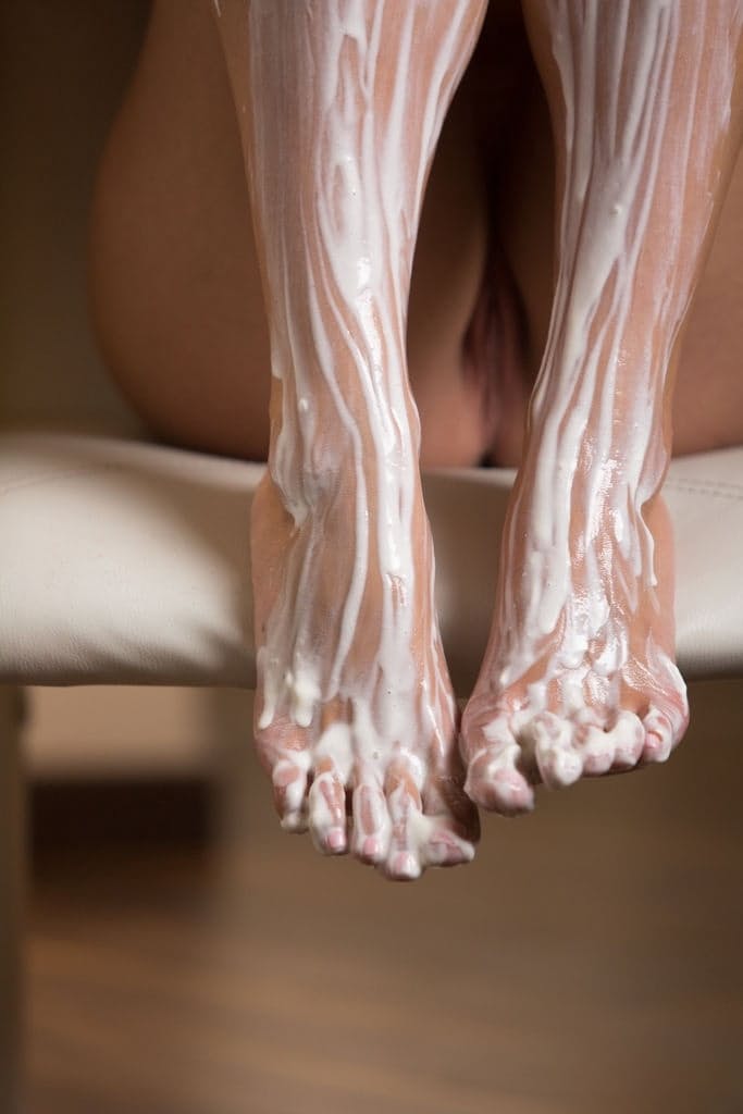 Nice blonde teen Sarika A covers her bare legs and feet with whip cream