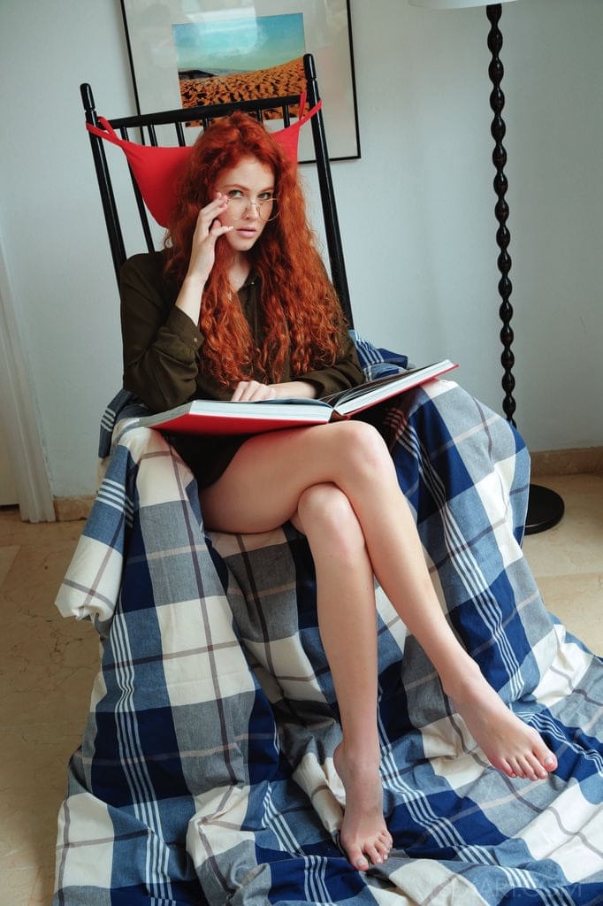 Natural redhead Adel C takes off her glasses before fingering her teen pussy
