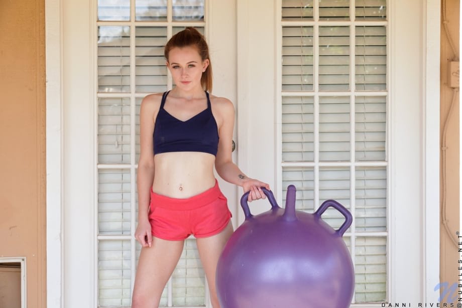 Petite teen Danni Rivers rides a dildo ball in knee socks after getting naked