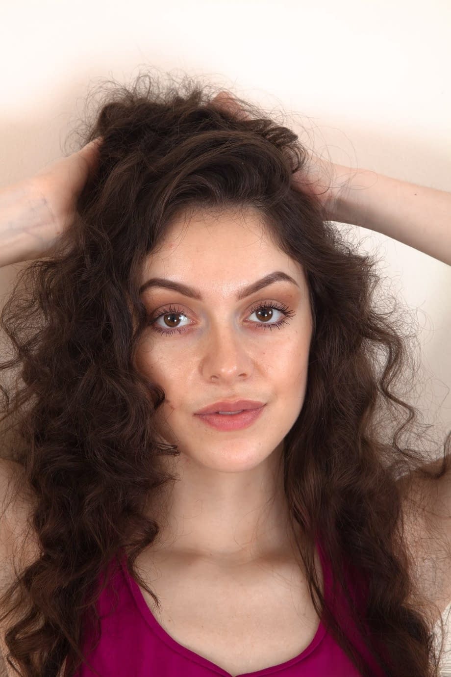 Slim brunette uncovers her tiny tits before showing her full bush