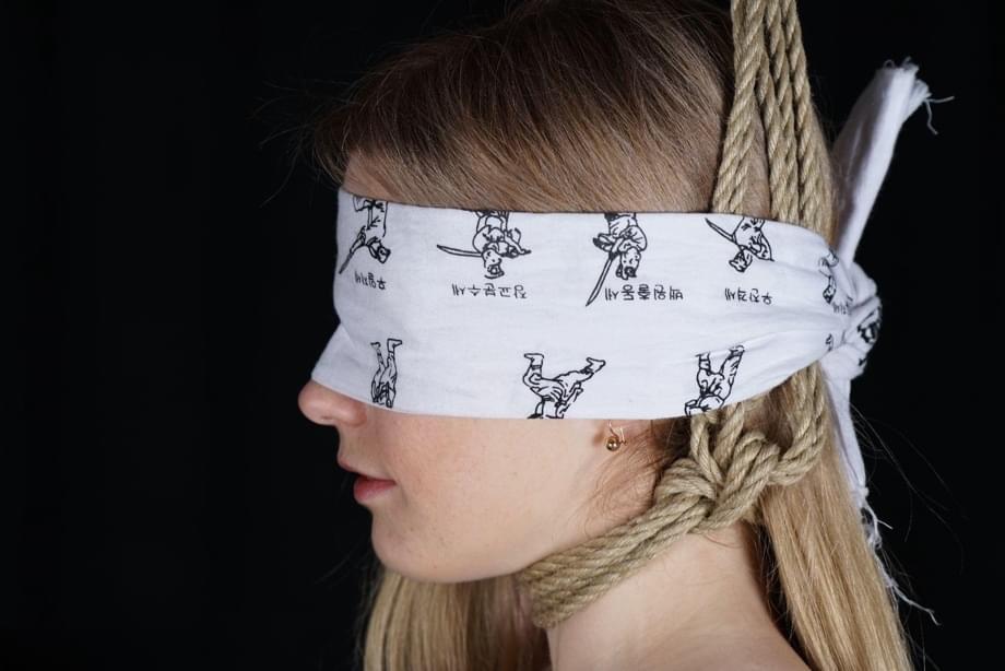 Naked blonde finds her nipples sticking out as she struggles against rope ties