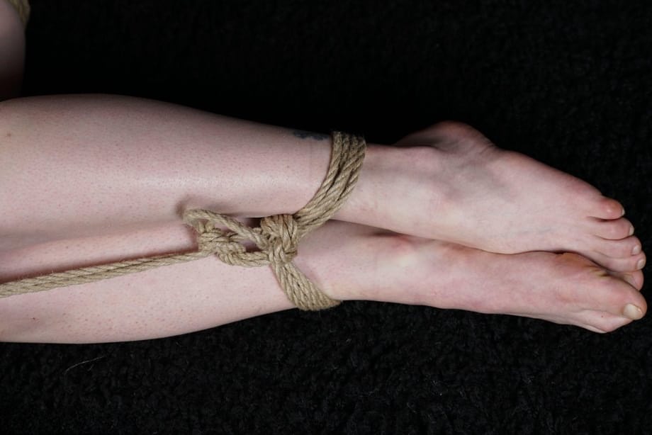Naked blonde finds her nipples sticking out as she struggles against rope ties