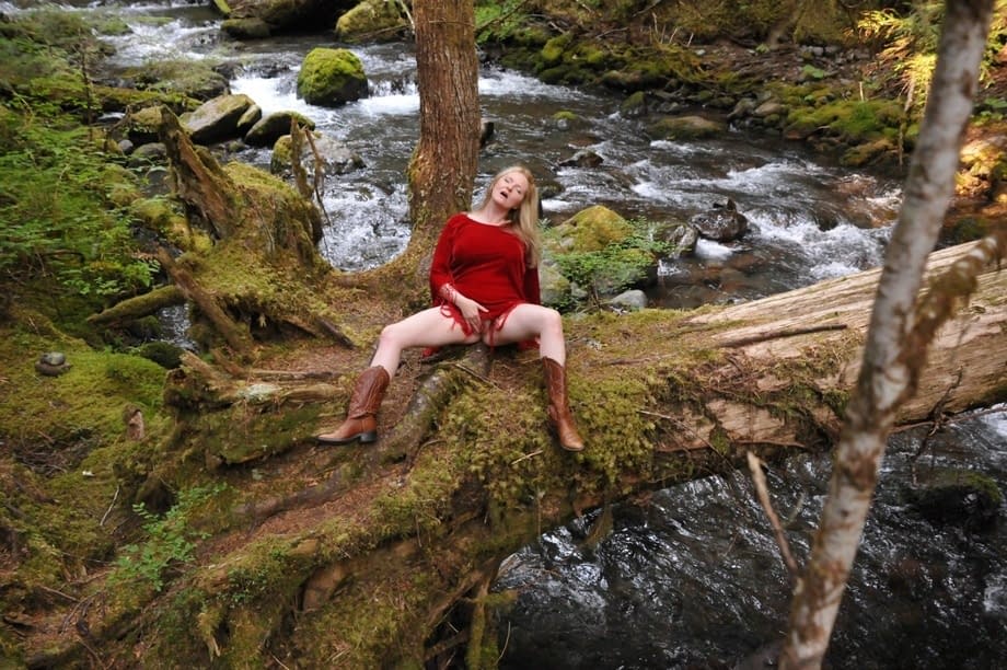 Mature amateur shows her bare ass after undressing in old growth forest