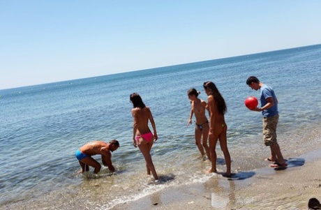 Horny college students partake in group sex while at the beach