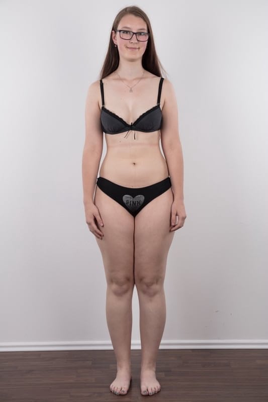 Nerdy teen Katerina stands naked as can be other than her glasses in the nude