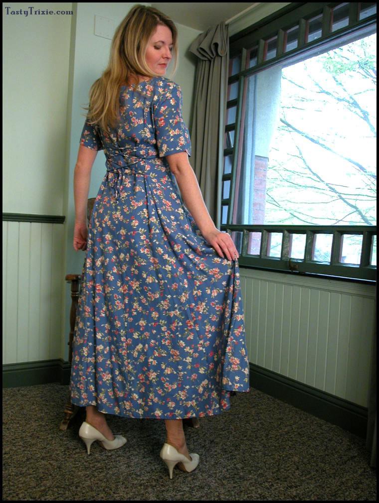 Mature lady Tasty Trixie hitches up her long dress before removing pink undies