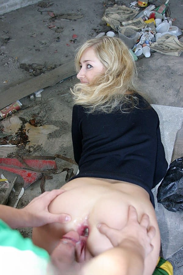 Blonde girl does hardcore anal in an abandoned building with strangers