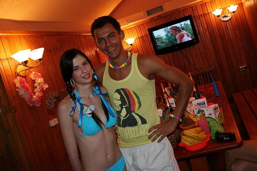 Horny college students partake in group sex during a Hawaiian themed party