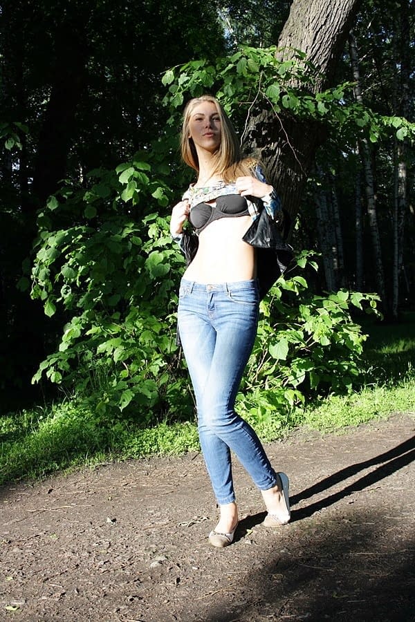 Slim amateur uncovers her small tits in blue jeans during homemade action