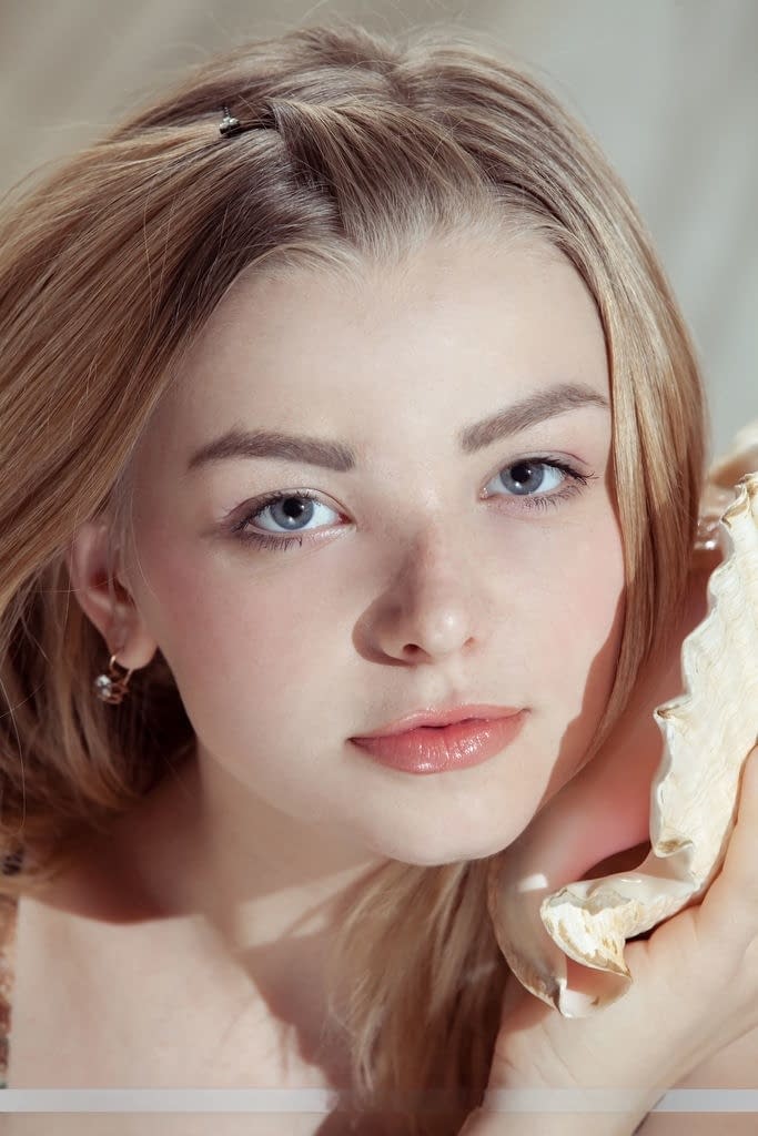 Beautiful teen with blonde hair Daniel Sea removes dress to pose totally naked