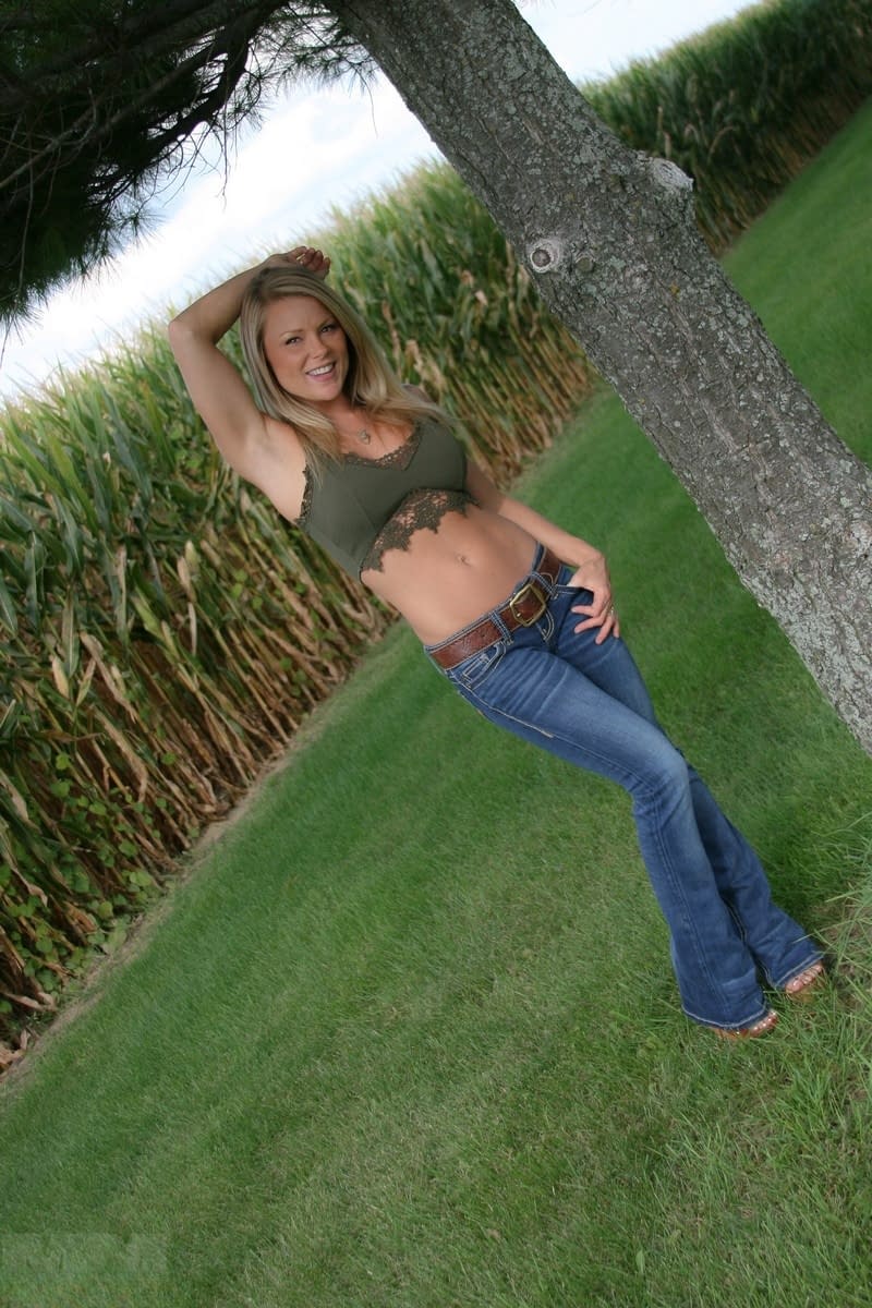 Hot MILF Madden removes her jeans in the backyard to tease in thong panties