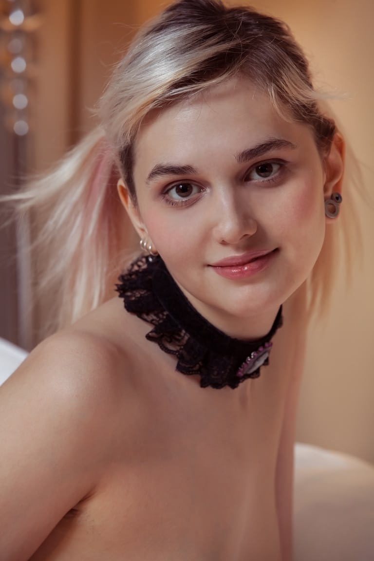 Slim blonde teen Vilett proudly shows her naked body in white stockings