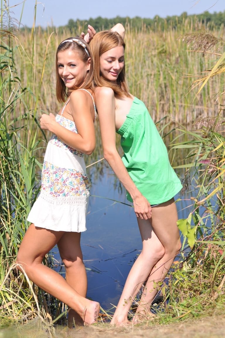 Young lesbians Nastya and Ashly get undressed atop a blanket on a dock