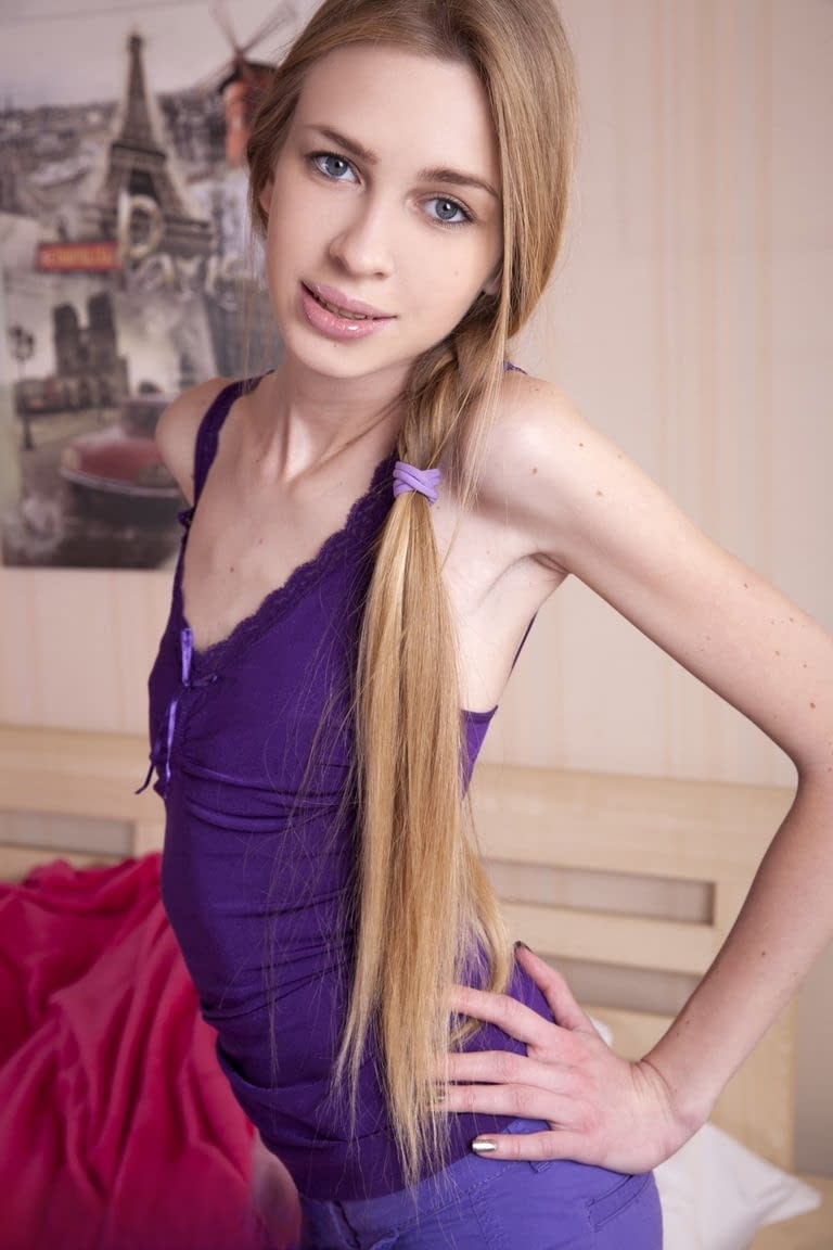 Slim teen Ivanka showcases her shaved pussy in socks and a long ponytail