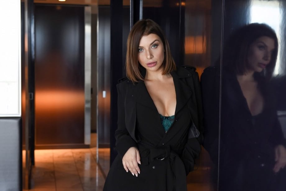 Brunette chick covers up her naked boobs in front of a Priest