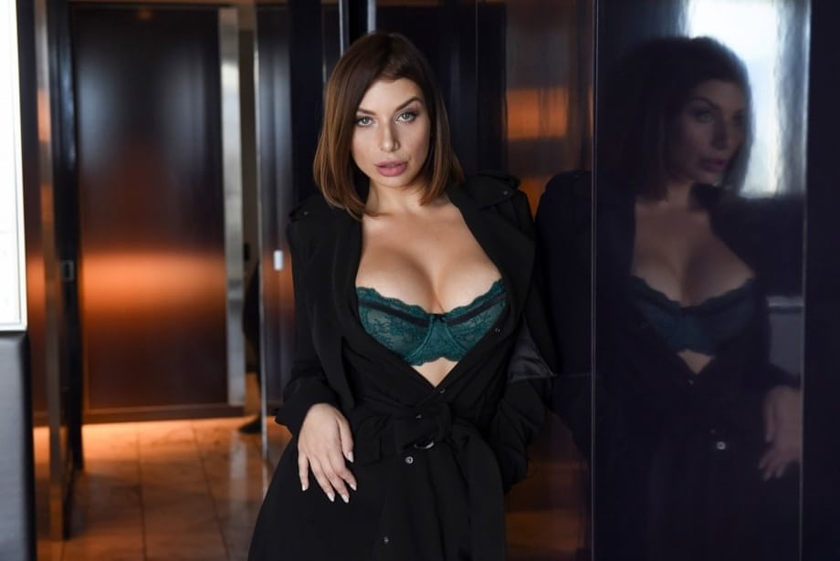 Brunette chick covers up her naked boobs in front of a Priest
