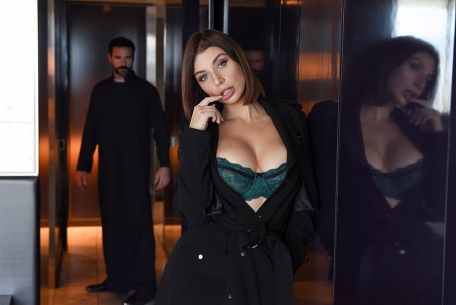 Brunette chick covers up her naked boobs in front of a Priest