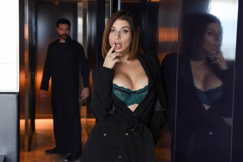 Brunette chick covers up her naked boobs in front of a Priest
