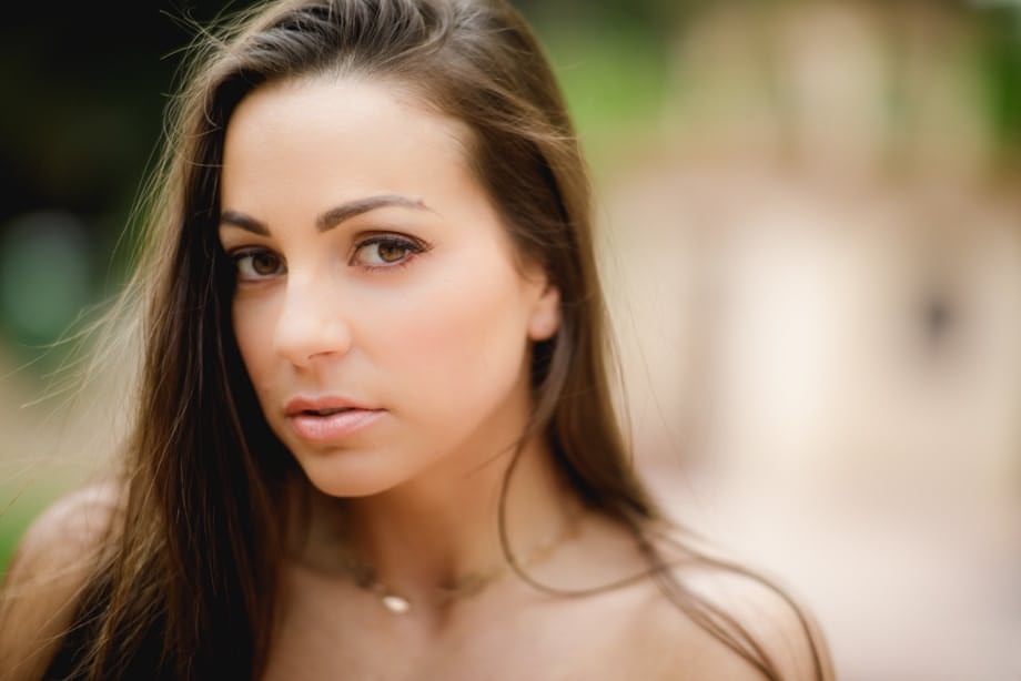 Brunette solo girl Abigail Mac exposes her big teen boobs in yard