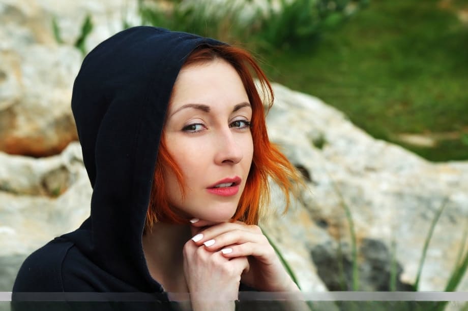 Fair skinned redhead Night A models naked atop a hill overlooking her town