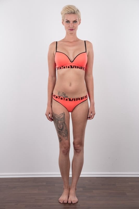 Tall blonde with a great ass stands totally naked after removing her clothes