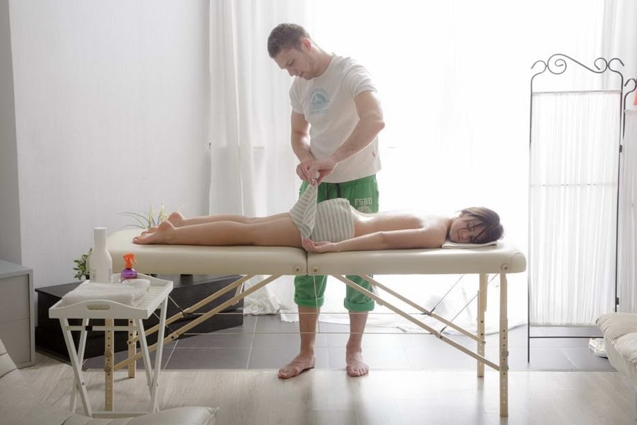 Young brunette with perky tits gets bum fucked by her masseur during a massage