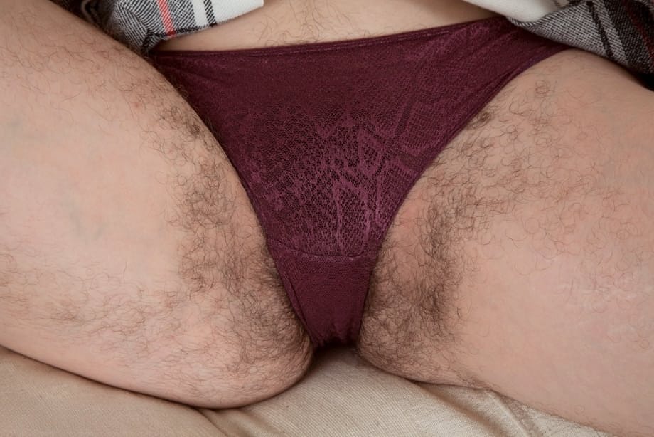 Amateur model hikes her skirt to show pubic hairs escaping from her underwear